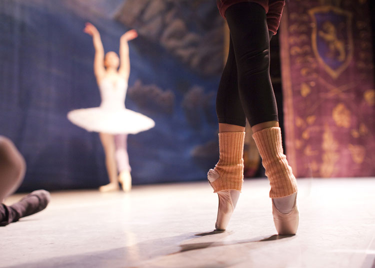 Two ballerinas from the Russian State Ballet of Siberia warming up on stage at The Colosseum in Watford