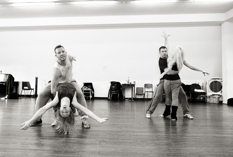 A black and white image of four dancers posing during a rehearsal for 'Anton & Erin Let's Do It'