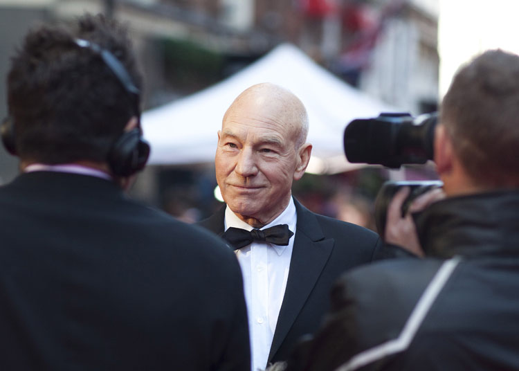 Actor Patrick Stewart being interviewed on the red carpet at the Royal Opera House
