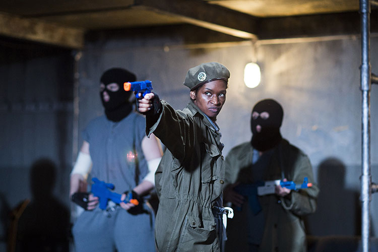 Jenny Jules holds a plastic gun whilst playing Cassius in 'Julius Caesar' at the Donmar theatre