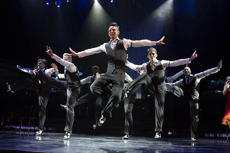Robbie Kmetoni and other male ensemble dancers