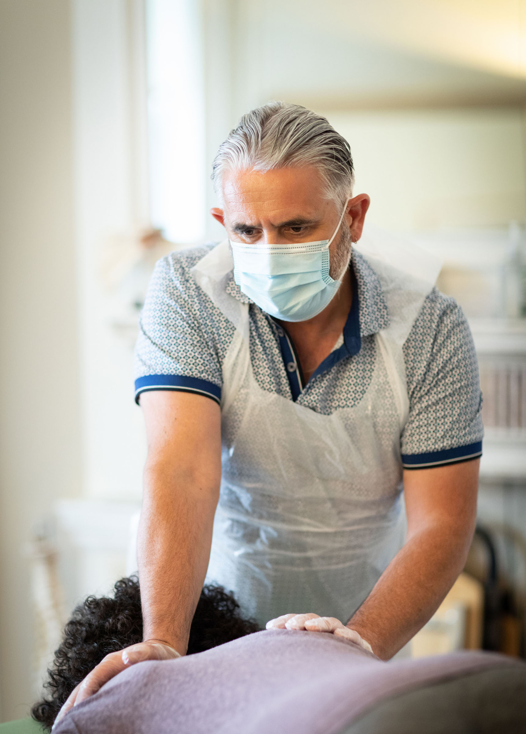 Physiotherapist Warrick McNeill seeing a client at 'Physioworks', his clinic in London.