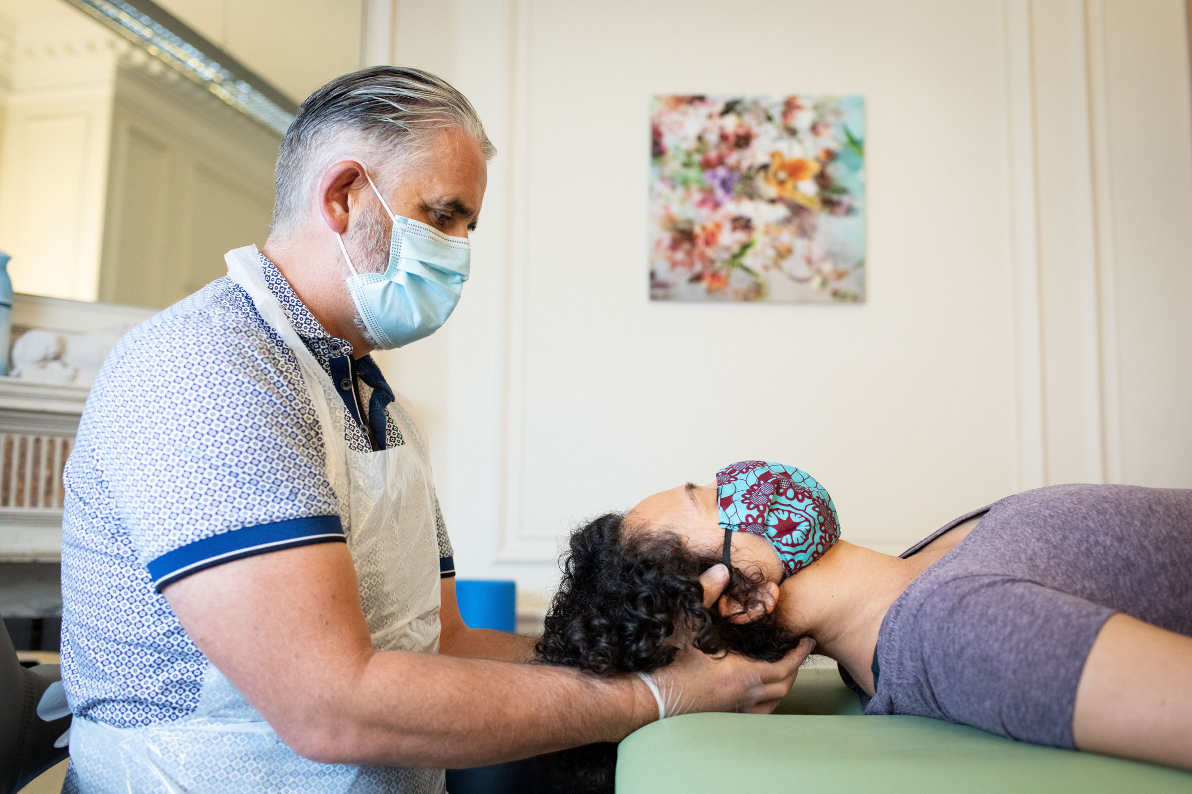 Warrick McNeill seeing a client at 'Physioworks', his clinic in London.