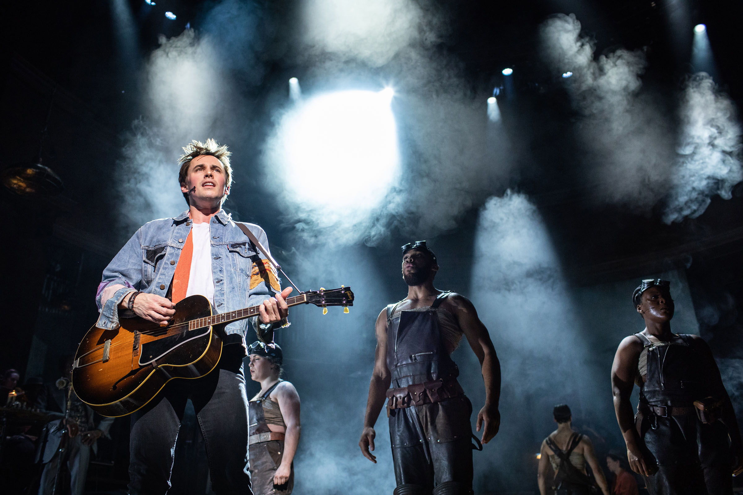 Reeve Carney (Orpheus) with the company of Hadestown, including Shaq Taylor and Seyi Omooba at the National Theatre
